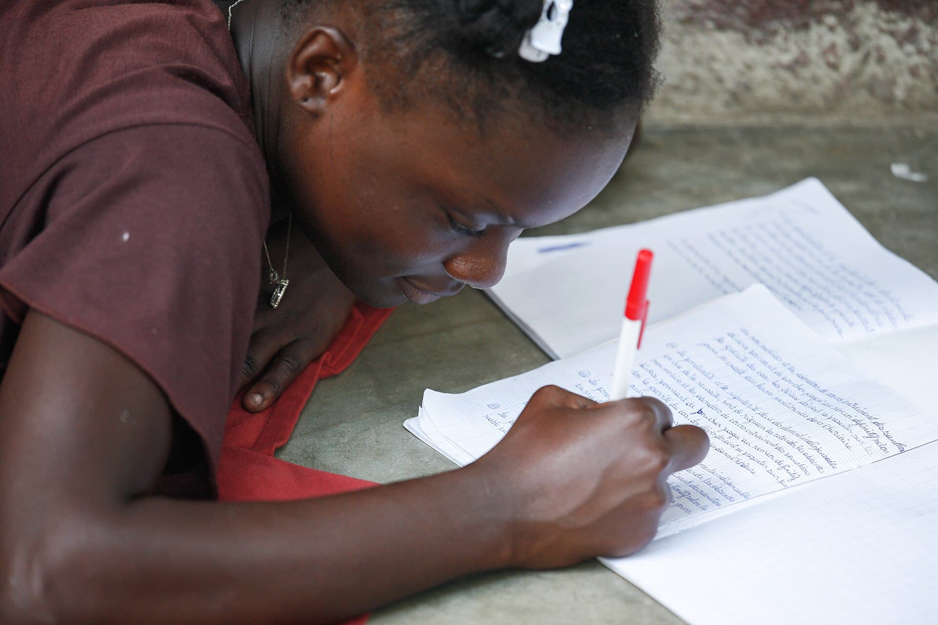 Someone working through notes and a book at a table