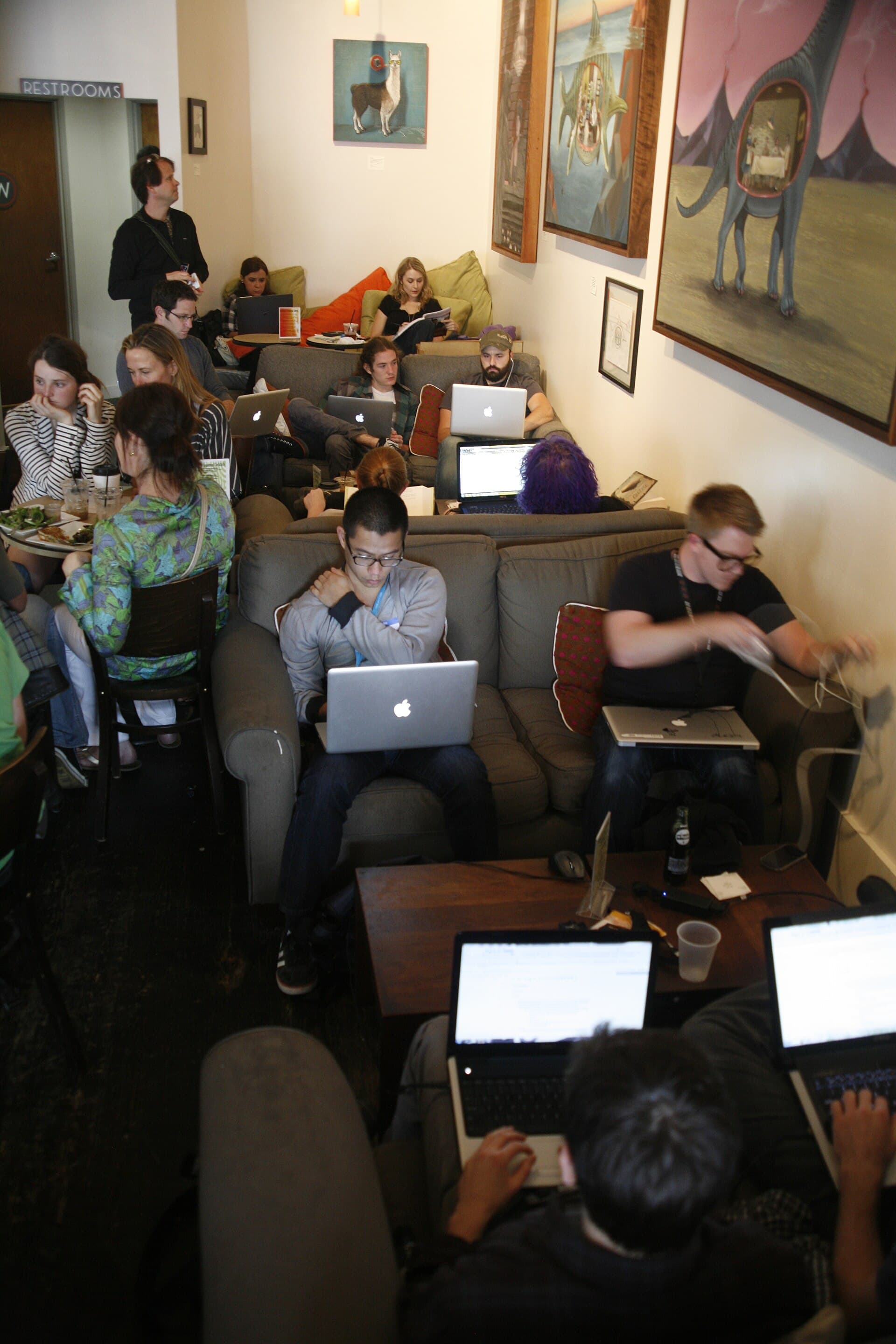 A person working on a laptop at a conference table
